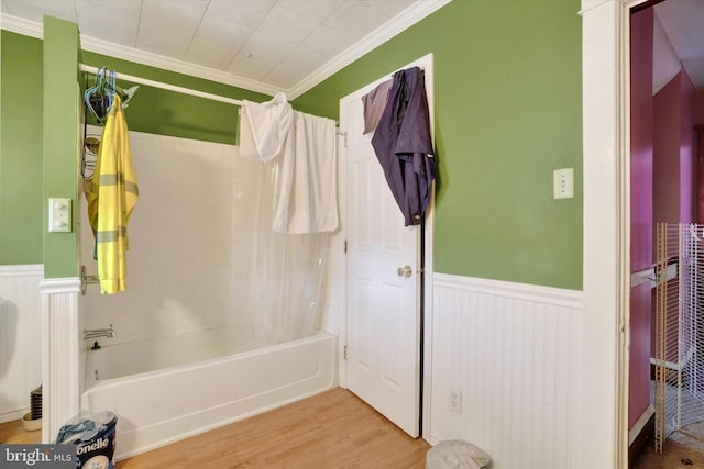 bathroom with wood-type flooring, ornamental molding, and shower / bathtub combination with curtain