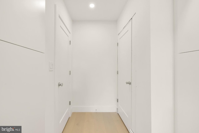 hallway with light hardwood / wood-style floors