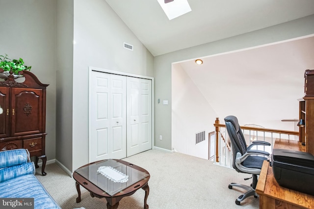 carpeted office space featuring a skylight, baseboards, and visible vents