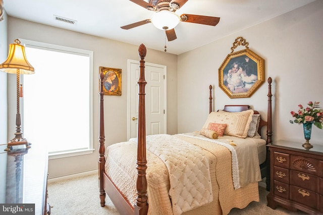 carpeted bedroom featuring visible vents and ceiling fan