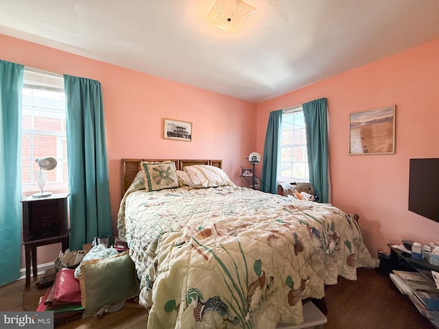 bedroom with dark hardwood / wood-style flooring