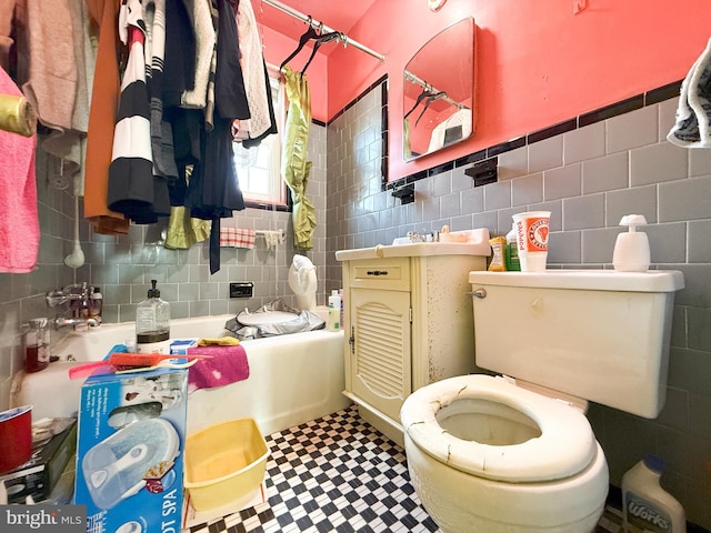 bathroom featuring washtub / shower combination, toilet, and tile walls