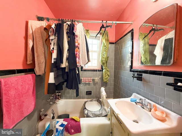 bathroom with vanity, tile walls, and decorative backsplash