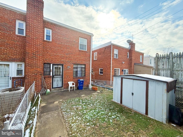 back of house featuring a patio, central AC, and a shed