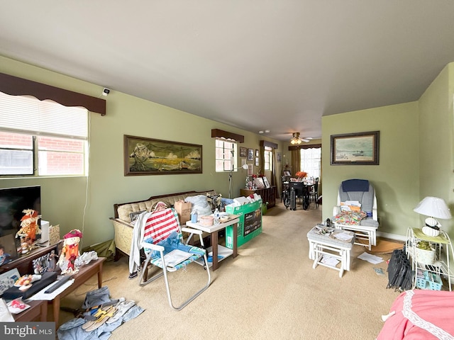 carpeted living room with plenty of natural light and ceiling fan