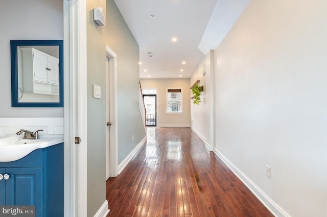 corridor featuring dark hardwood / wood-style floors and sink