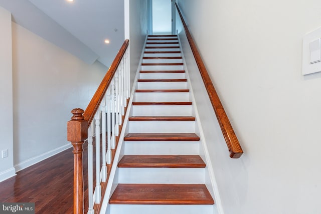 stairs featuring wood-type flooring