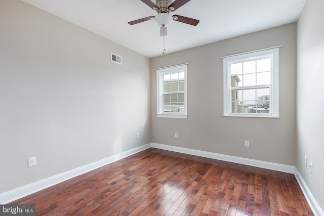 spare room with ceiling fan and dark hardwood / wood-style flooring