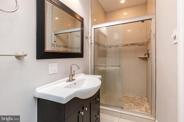 bathroom with vanity and a shower with shower door