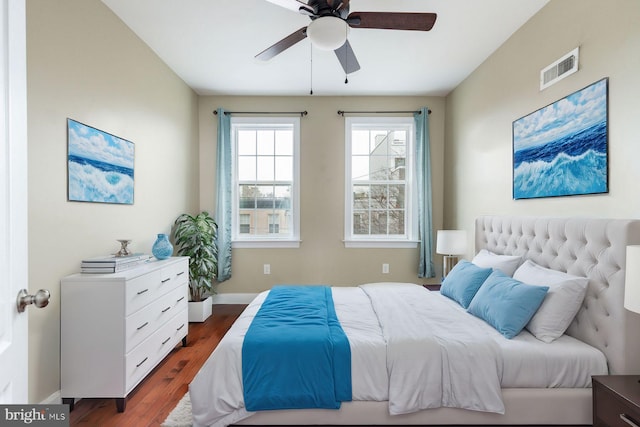 bedroom with ceiling fan and dark hardwood / wood-style flooring