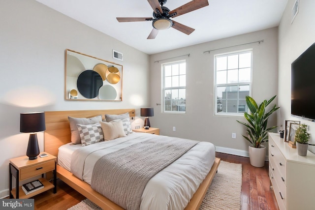 bedroom with ceiling fan and dark hardwood / wood-style flooring