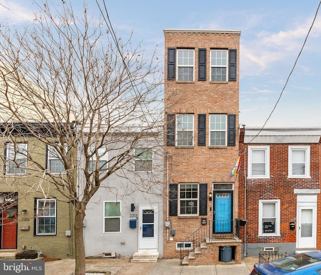 2211 Almond St, Philadelphia, PA 19125 - townhome / multi-family property featuring brick siding and entry steps