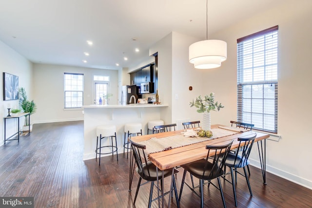 dining space featuring dark hardwood / wood-style floors