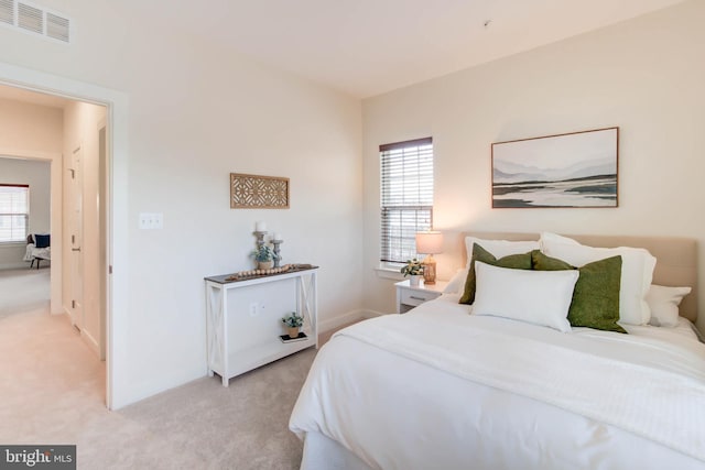 bedroom featuring light carpet