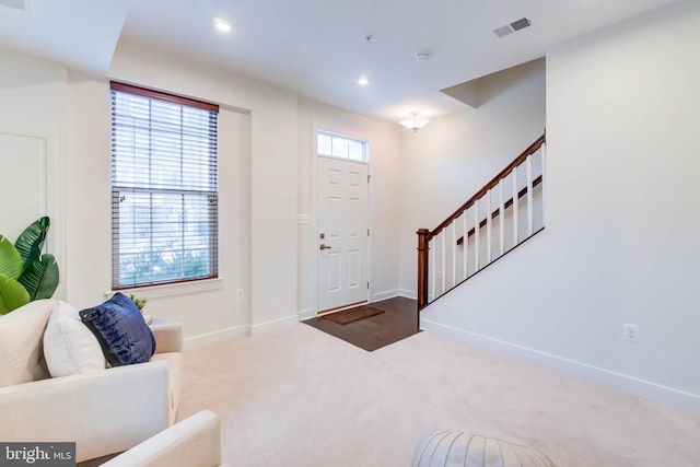 view of carpeted foyer entrance