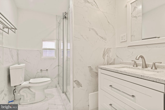 bathroom with an enclosed shower, vanity, tile walls, and toilet