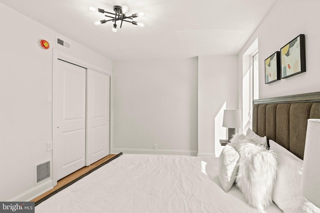 bedroom with a closet and hardwood / wood-style flooring