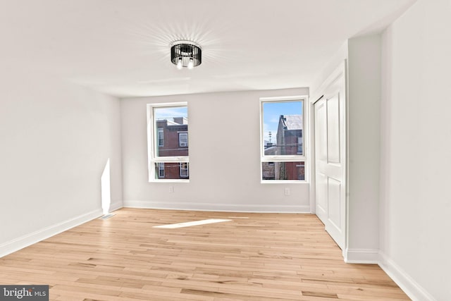 unfurnished room featuring light hardwood / wood-style floors