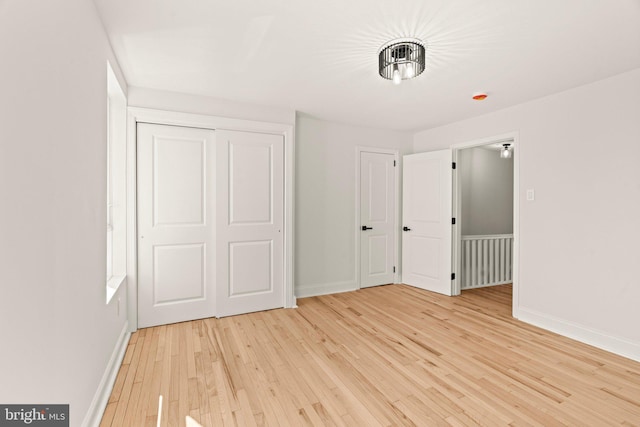 unfurnished bedroom featuring a closet and light hardwood / wood-style floors