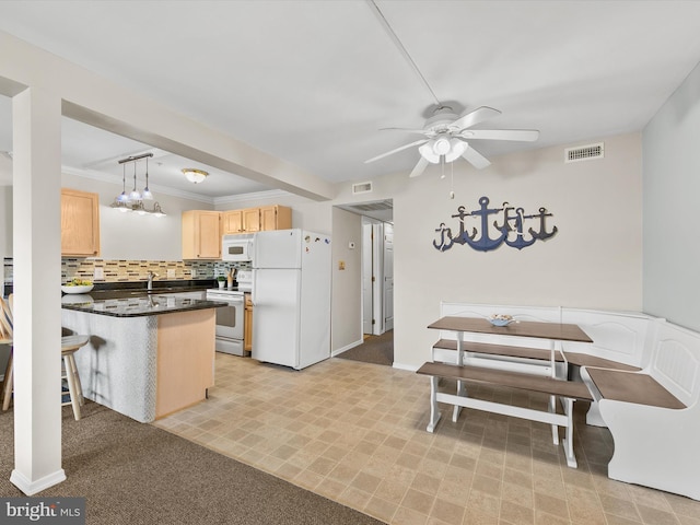 kitchen with white appliances, hanging light fixtures, breakfast area, light brown cabinetry, and kitchen peninsula