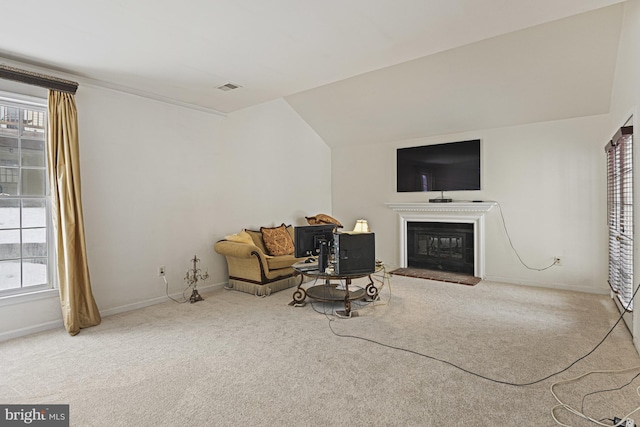 living room featuring carpet floors and lofted ceiling