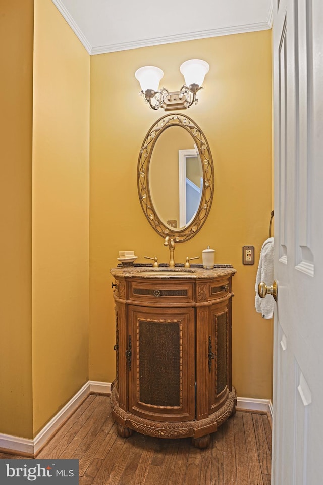 bathroom featuring hardwood / wood-style floors, vanity, and crown molding