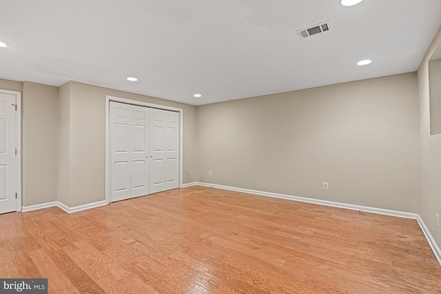 unfurnished bedroom with a closet and light hardwood / wood-style floors