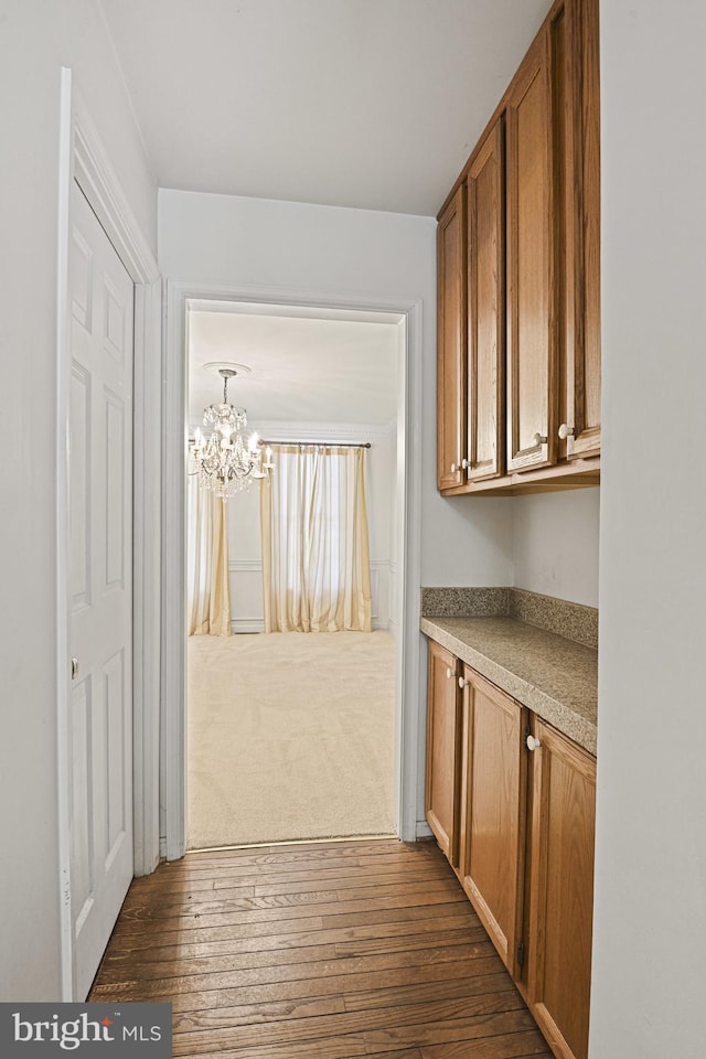 interior space featuring dark hardwood / wood-style flooring and a notable chandelier