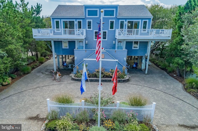 exterior space with a carport and a balcony