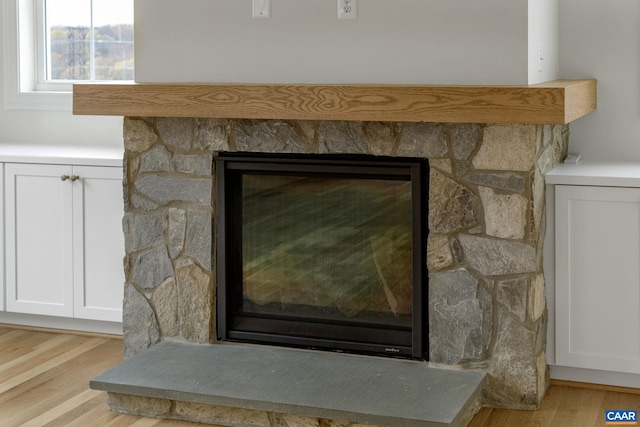 room details featuring a fireplace and hardwood / wood-style floors