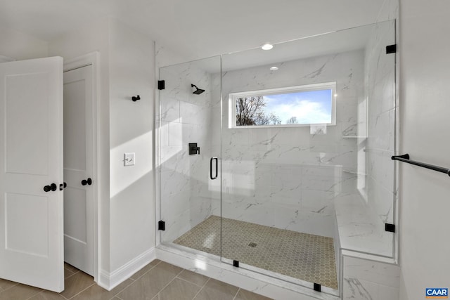 bathroom featuring a shower with shower door and tile patterned floors