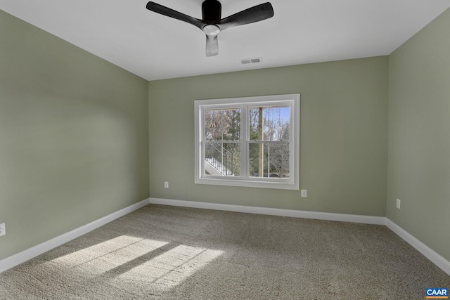 carpeted spare room featuring ceiling fan