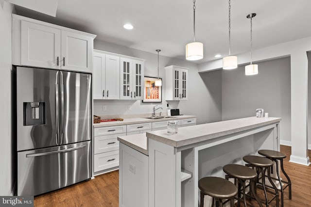 1335 Ashton Rd, Mechanicsburg, PA 17055 - kitchen featuring stainless steel fridge, a center island, light countertops, white cabinetry, and a sink
