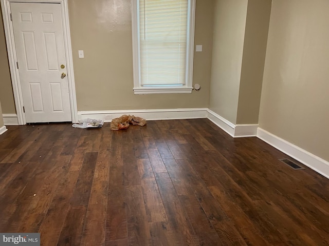 empty room featuring dark wood-type flooring