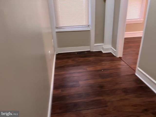 corridor featuring dark wood-type flooring