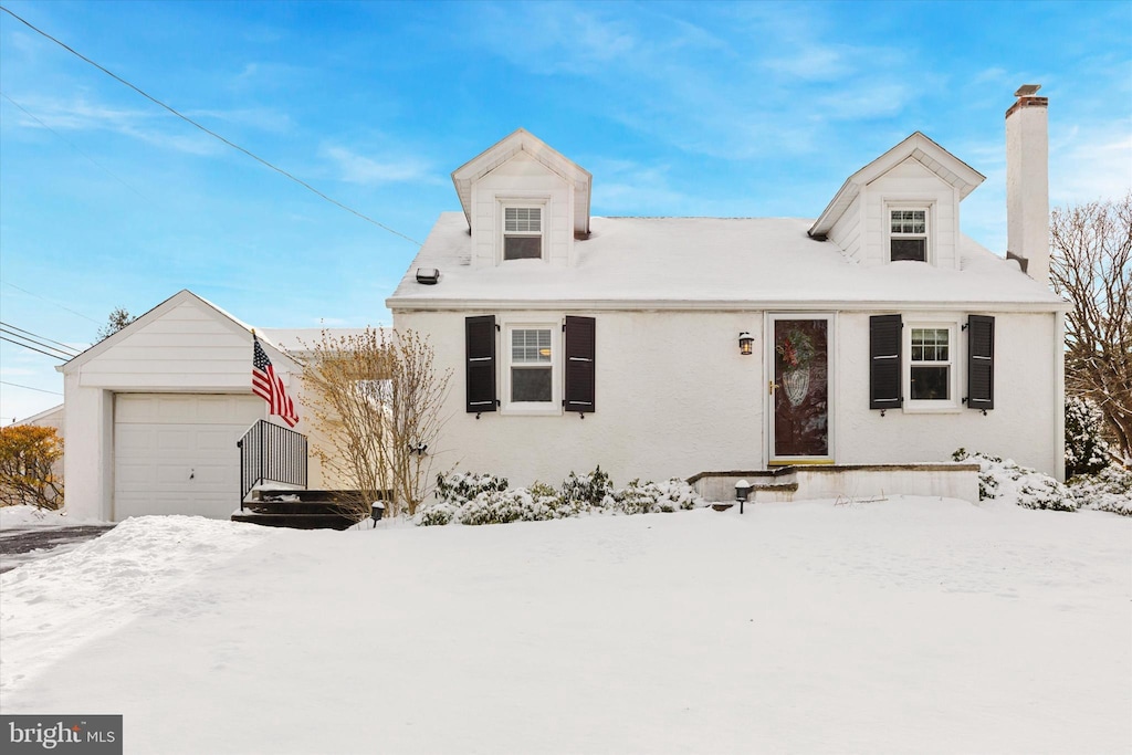 cape cod-style house with a garage