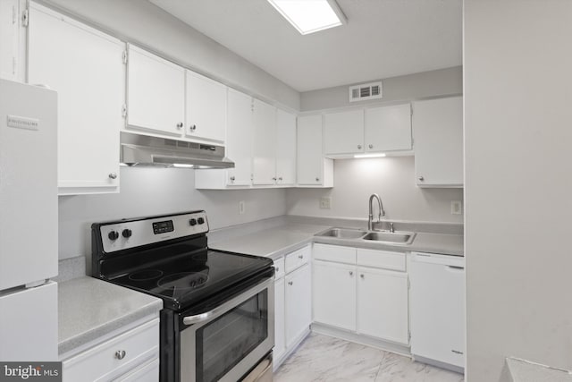 kitchen featuring white appliances, sink, and white cabinets