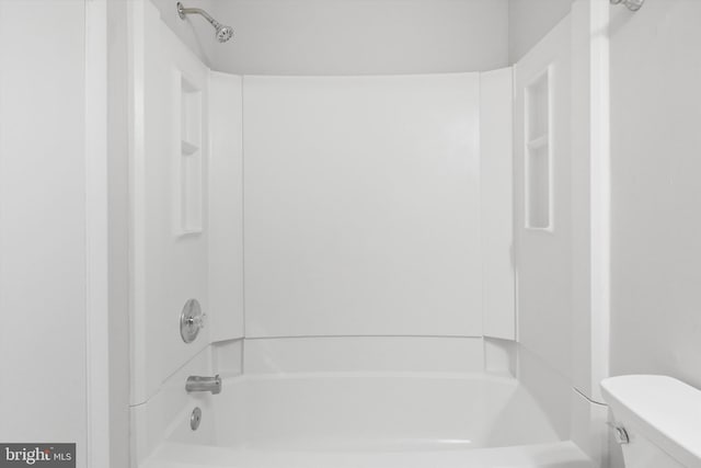 bathroom featuring toilet and shower / bathing tub combination