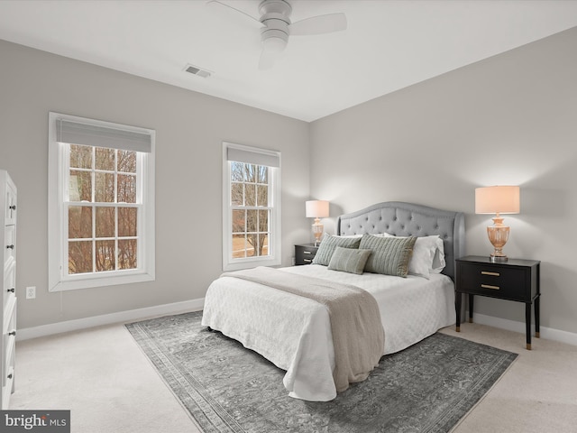 bedroom featuring baseboards, a ceiling fan, visible vents, and light colored carpet