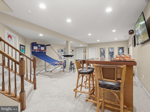 bar featuring recessed lighting, carpet flooring, baseboards, stairway, and a dry bar