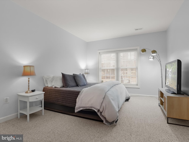 bedroom featuring light colored carpet, visible vents, and baseboards