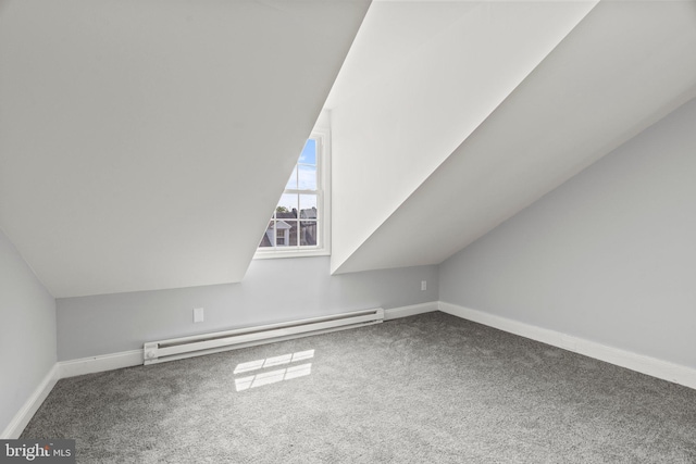 bonus room with a baseboard heating unit, carpet flooring, and vaulted ceiling