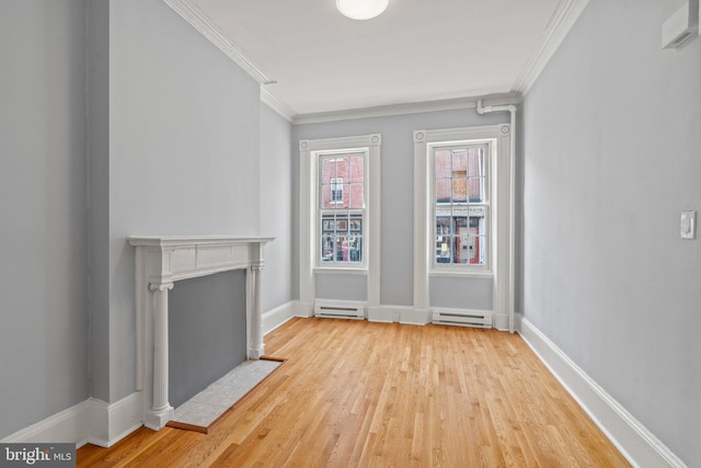 unfurnished living room with baseboard heating, ornamental molding, and light hardwood / wood-style floors