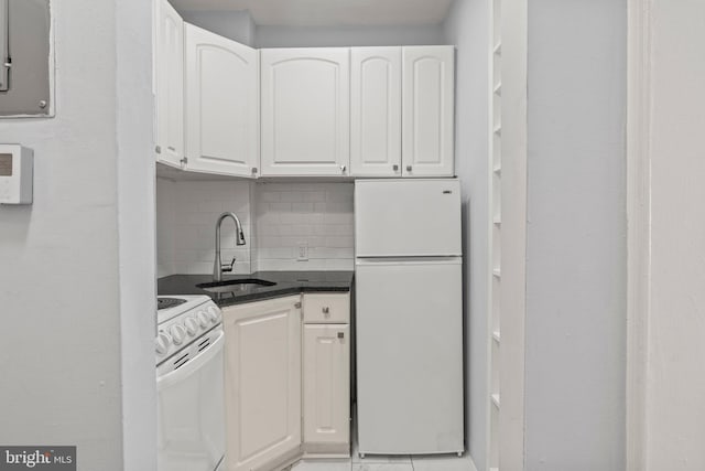 kitchen featuring decorative backsplash, sink, white cabinets, and white appliances