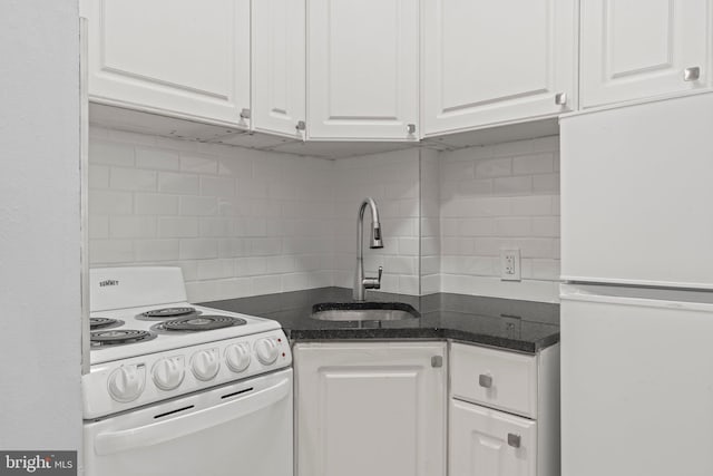 kitchen with tasteful backsplash, sink, white appliances, and white cabinetry