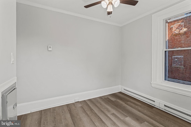 unfurnished room with ceiling fan, a baseboard heating unit, crown molding, and wood-type flooring