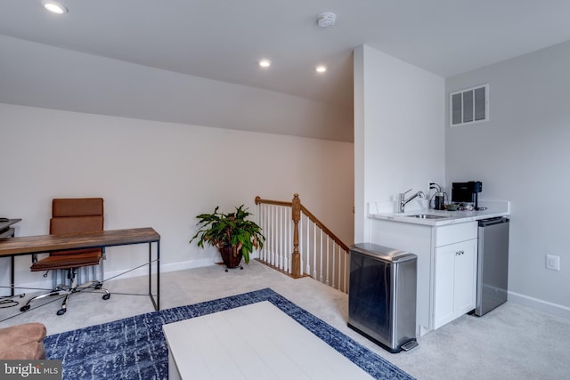 office space featuring sink and light carpet