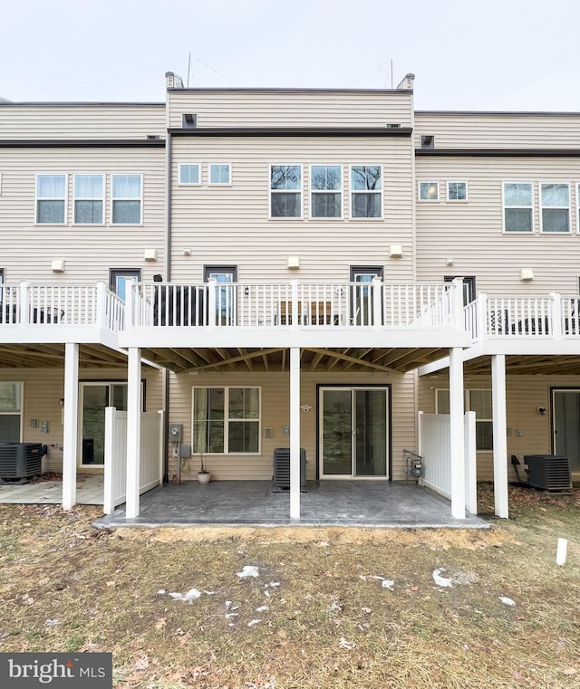 rear view of house with a patio and central AC unit