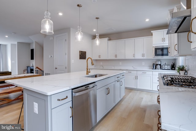 kitchen featuring sink, white cabinets, dishwasher, and a center island with sink