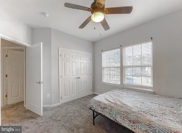 bedroom with light carpet, ceiling fan, and a closet